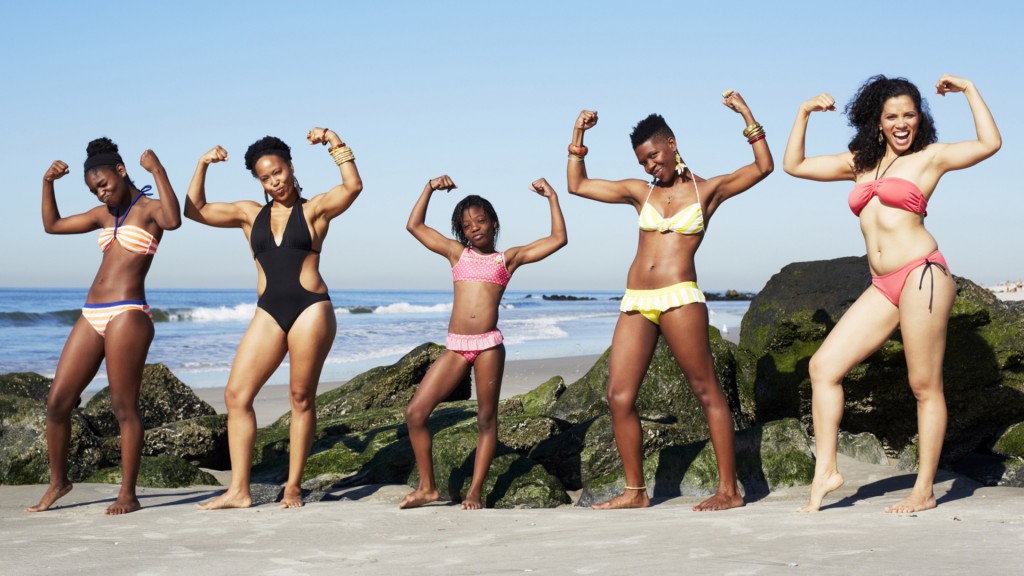 women-striking-power-pose-on-beach